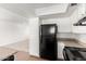 Bright kitchen with white cabinets and trim and black refrigerator at 9118 W Cameron Dr, Peoria, AZ 85345