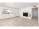 Open living room featuring neutral tile floors, a white brick fireplace, and bright natural light at 9118 W Cameron Dr, Peoria, AZ 85345