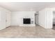 Spacious living room with tile floors, a charming brick fireplace, and ample natural light at 9118 W Cameron Dr, Peoria, AZ 85345