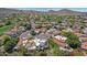 Expansive aerial view of homes nestled in a lush community with verdant golf courses and majestic mountain backdrops at 9241 S 50Th St, Phoenix, AZ 85044