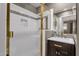 Modern bathroom with a glass-enclosed shower, tiled walls, and a vanity with stylish fixtures at 9241 S 50Th St, Phoenix, AZ 85044