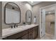 Stylish bathroom with double vanity, modern sinks, mirrors, and an adjacent shower at 9241 S 50Th St, Phoenix, AZ 85044