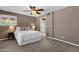 Cozy bedroom with a ceiling fan, a window for natural light, and an ensuite bathroom at 9241 S 50Th St, Phoenix, AZ 85044