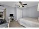 Bedroom featuring a ceiling fan, TV, closet, and a window providing natural light at 9241 S 50Th St, Phoenix, AZ 85044
