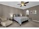 Bedroom with a ceiling fan, comfortable chair, carpet flooring and an en suite bathroom at 9241 S 50Th St, Phoenix, AZ 85044