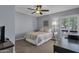 Bright bedroom featuring a comfortable bed, desk, and a window providing natural light at 9241 S 50Th St, Phoenix, AZ 85044