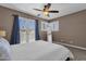 This bedroom features a ceiling fan, natural light, and private access to an outdoor patio at 9241 S 50Th St, Phoenix, AZ 85044
