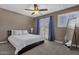 Comfortable bedroom boasts a ceiling fan, carpet, and private access to an outdoor patio at 9241 S 50Th St, Phoenix, AZ 85044