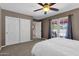 Bright bedroom featuring a ceiling fan, double doors to a patio, and ample closet space at 9241 S 50Th St, Phoenix, AZ 85044