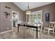 Inviting dining room with a modern light fixture and window with natural light at 9241 S 50Th St, Phoenix, AZ 85044