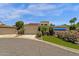 Striking exterior view of home with desert landscaping, mature trees and attached three-car garage at 9241 S 50Th St, Phoenix, AZ 85044