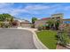 Beautiful home with a two-car garage, lush landscaping, and well-maintained artificial lawn at 9241 S 50Th St, Phoenix, AZ 85044