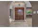 Elegant foyer with marble flooring, arched doorway, and views of the upper level at 9241 S 50Th St, Phoenix, AZ 85044