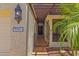 Inviting front entry with iron gate, lantern lighting, and decorative house number at 9241 S 50Th St, Phoenix, AZ 85044