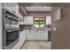 Bright kitchen featuring granite countertops, stainless steel appliances, and white cabinetry at 9241 S 50Th St, Phoenix, AZ 85044