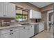 Bright kitchen featuring granite countertops, stainless steel appliances, and white cabinetry at 9241 S 50Th St, Phoenix, AZ 85044