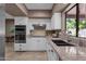 Bright kitchen featuring granite countertops, stainless steel appliances, and white cabinetry at 9241 S 50Th St, Phoenix, AZ 85044