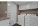 Clean laundry area with washer, dryer, built-in cabinets, and counter space at 9241 S 50Th St, Phoenix, AZ 85044