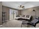 Comfortable living room featuring plush seating, a ceiling fan, and a sliding door to the outside at 9241 S 50Th St, Phoenix, AZ 85044