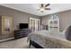 Main bedroom with a ceiling fan, a king bed, and abundant natural light at 9241 S 50Th St, Phoenix, AZ 85044