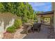 Outdoor patio with seating is surrounded by lush landscaping, offering serene spot for relaxation at 9241 S 50Th St, Phoenix, AZ 85044