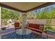Inviting covered patio with comfortable seating and serene backyard water feature at 9241 S 50Th St, Phoenix, AZ 85044