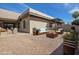 Backyard patio boasts a seating area with modern wood furniture, perfect for outdoor relaxation at 9463 E Jenan Dr, Scottsdale, AZ 85260