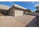 Rear exterior of home shows a gravel yard and covered patio area, ready for outdoor living at 9463 E Jenan Dr, Scottsdale, AZ 85260