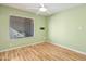 Bright empty bedroom with wood floors, a large window and neutral walls, great for customization at 9463 E Jenan Dr, Scottsdale, AZ 85260