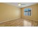 A sunny bedroom with light yellow walls and sleek laminate floors offers a serene retreat at 9463 E Jenan Dr, Scottsdale, AZ 85260