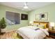 Modern bedroom featuring a ceiling fan, TV, and artwork; the room offers comfort and style at 9463 E Jenan Dr, Scottsdale, AZ 85260