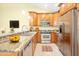 Spacious kitchen featuring stainless steel appliances, granite countertops, and wood cabinetry at 9463 E Jenan Dr, Scottsdale, AZ 85260