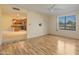 Bright living room with hardwood flooring offering ample space and a window, flowing to the open kitchen at 9463 E Jenan Dr, Scottsdale, AZ 85260