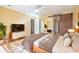 Bright and airy main bedroom with hardwood flooring and a barn door adjacent to a sliding mirrored closet at 9463 E Jenan Dr, Scottsdale, AZ 85260