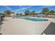Community pool with a large deck, lounge chairs and covered seating area at 9463 E Jenan Dr, Scottsdale, AZ 85260