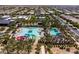 A picturesque aerial view of community pool, splash pad and lush landscaping, offering a resort-like experience at 9837 E Tiburon Ave, Mesa, AZ 85212