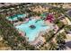 Beautiful aerial shot of community pool area with slides, chairs and palm trees on a sunny day at 9837 E Tiburon Ave, Mesa, AZ 85212