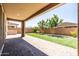 Relaxing backyard patio with brick pavers, green lawn, and mature landscaping for outdoor enjoyment at 9837 E Tiburon Ave, Mesa, AZ 85212
