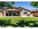 Spacious backyard featuring artificial grass and covered patio at 9837 E Tiburon Ave, Mesa, AZ 85212