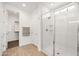Bright bathroom boasts glass shower, white subway tile, and a separate door to walk in closet at 9837 E Tiburon Ave, Mesa, AZ 85212