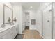 Well-lit bathroom featuring double vanity, walk-in shower, and walk-in closet at 9837 E Tiburon Ave, Mesa, AZ 85212