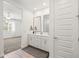 Well-lit bathroom features double sinks and mirrors plus doorway leading to the main bedroom at 9837 E Tiburon Ave, Mesa, AZ 85212