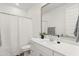 Modern bathroom with a large vanity, a stylish mirror, and a shower with a white curtain at 9837 E Tiburon Ave, Mesa, AZ 85212