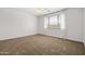 Bright bedroom with neutral carpet and large windows at 9837 E Tiburon Ave, Mesa, AZ 85212