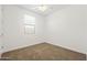 Bright and spacious bedroom with a ceiling fan, natural light, and plush carpet flooring at 9837 E Tiburon Ave, Mesa, AZ 85212