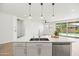 Kitchen island with a stainless dishwasher and a sink with a view of the yard at 9837 E Tiburon Ave, Mesa, AZ 85212