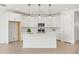 Bright kitchen features white cabinets, an island, and stainless steel appliances at 9837 E Tiburon Ave, Mesa, AZ 85212
