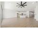 Open-concept living room flows into the kitchen with white cabinetry and an island at 9837 E Tiburon Ave, Mesa, AZ 85212