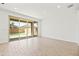 Bright living room boasts wood-look tile flooring and sliding glass doors to the backyard at 9837 E Tiburon Ave, Mesa, AZ 85212