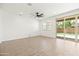 Spacious living room features wood-look tile floors, a ceiling fan and sliding glass doors at 9837 E Tiburon Ave, Mesa, AZ 85212
